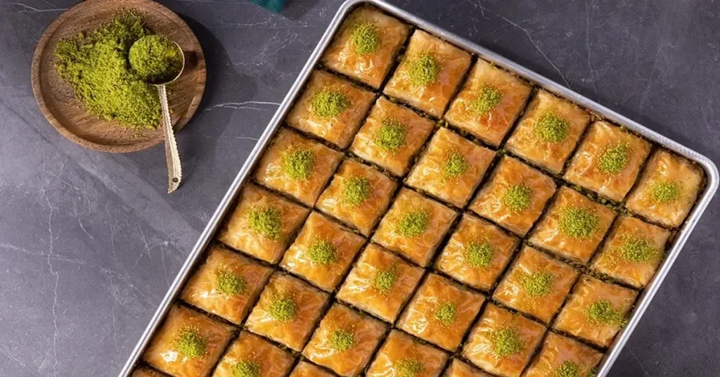 A baking dish of baklava with peanuts.