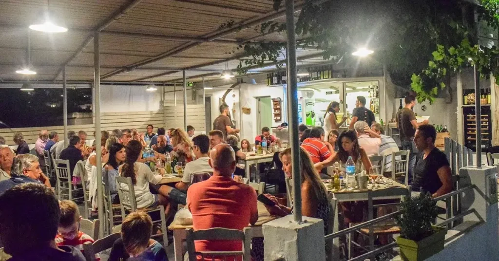 People eating at the balcony of Aranto restaurant, one of the best in Paros Greece.