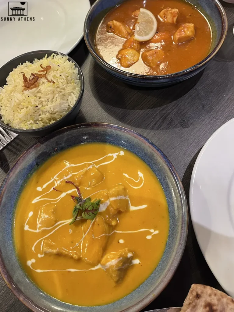 A plate of rich, creamy chicken curry at Gautam's, accompanied by a bowl of rice, is the perfect way to end a long day on your 4 days in Edinburgh itinerary.