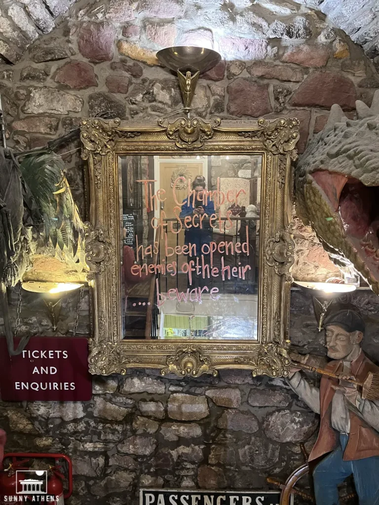 A Harry Potter-themed mirror at the Museum Context, writing "The Chamber of Secrets has been opened, enemies of the heir... beware".