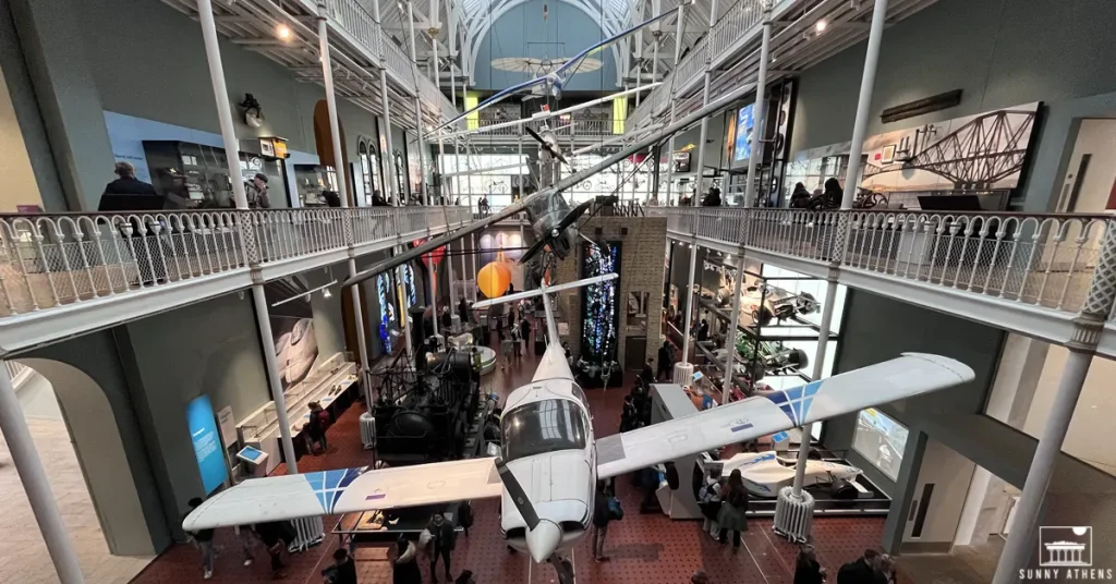 Four airplanes of different eras hanging from the roof of the National Museum of Scotland.