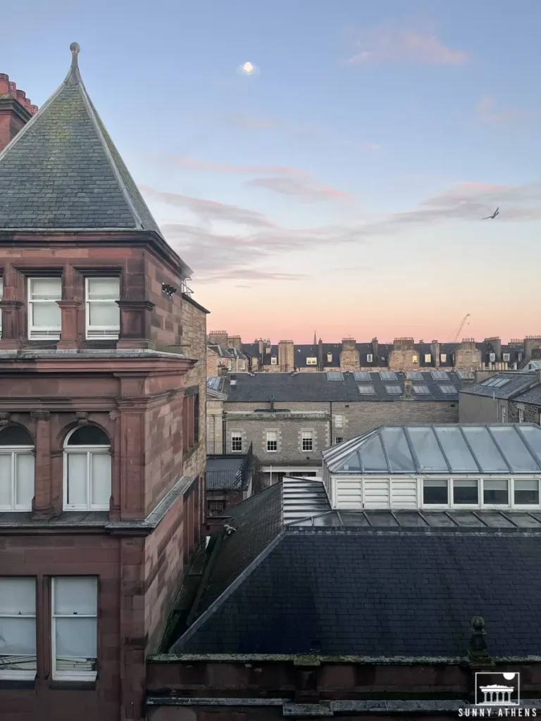 4 days in Edinburgh itinerary: rooftop view from the Ten Hill Place Hotel over the city showing detailed architecture and the glow of the setting sun.