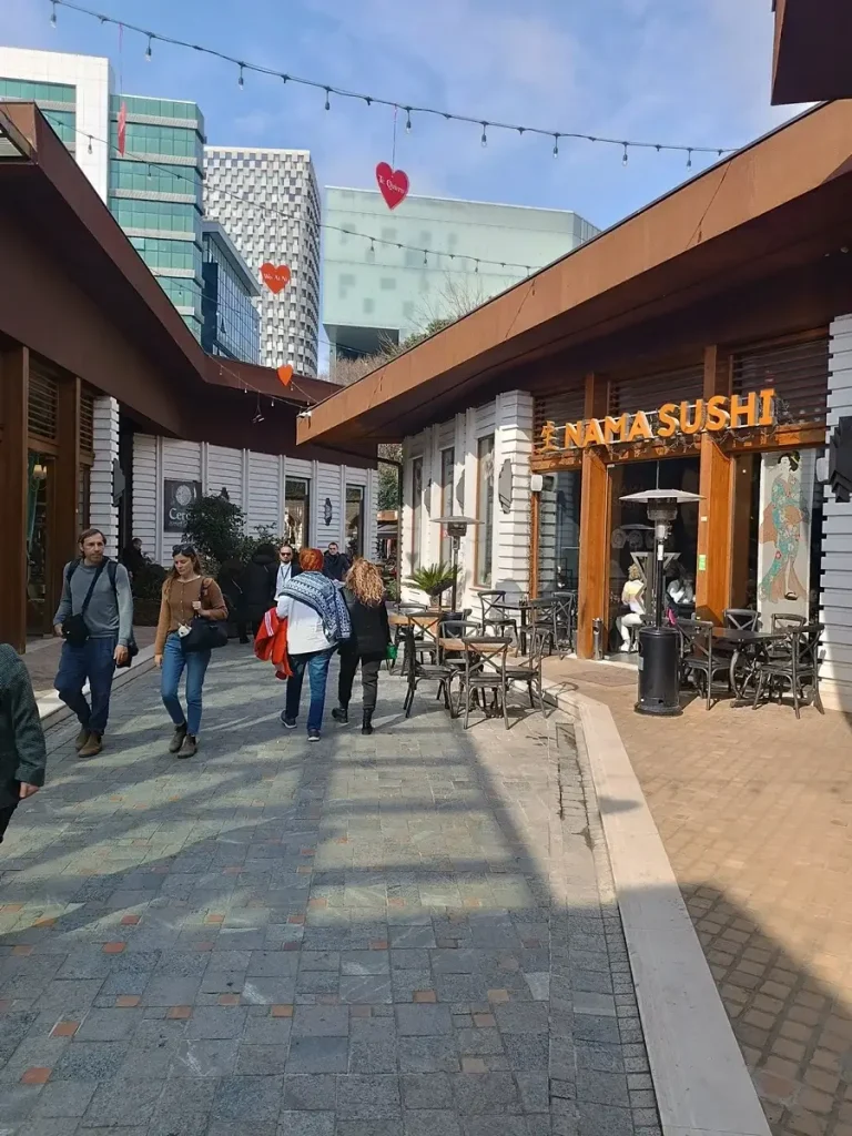 People crossing a pedestrian road at Tirana Castle.