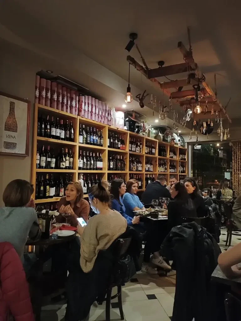 People chatting and having a great time in a cozy vinoteca in the center of Tirana.