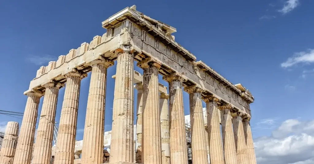 Acropolis myths and legends: corner view of the unique marble Parthenon temple with the Athens blue sky above.