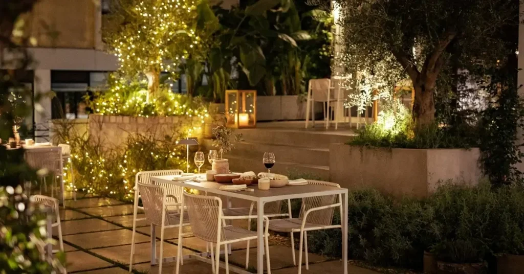 A beautifully decorated dinner table at night in the garden of Zohos, one of the best local Greek food restaurants in Plaka, Athens.