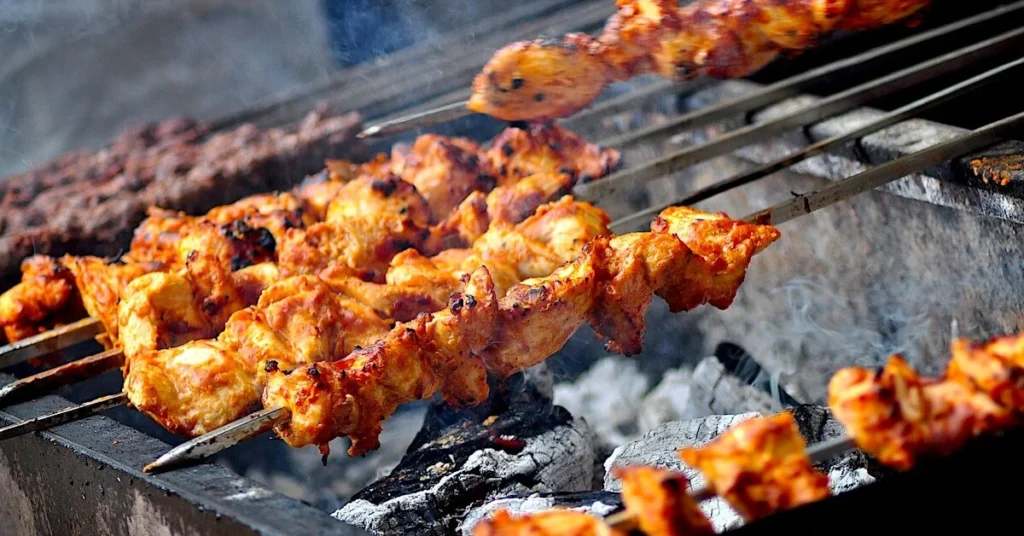 Best traditional souvlaki in Athens: Juicy skewered meat roasting over a charcoal grill