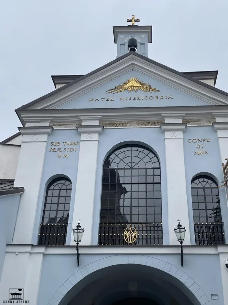 The Gate of Dawn in Vilnius with its iconic blue facade and golden inscriptions.