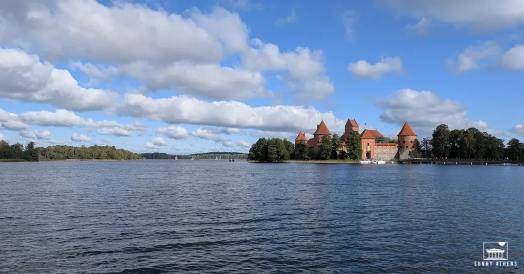 3 days itinerary of Vilnius: Trakai Island Castle surrounded by the waters of Lake Galve under a clear blue sky.