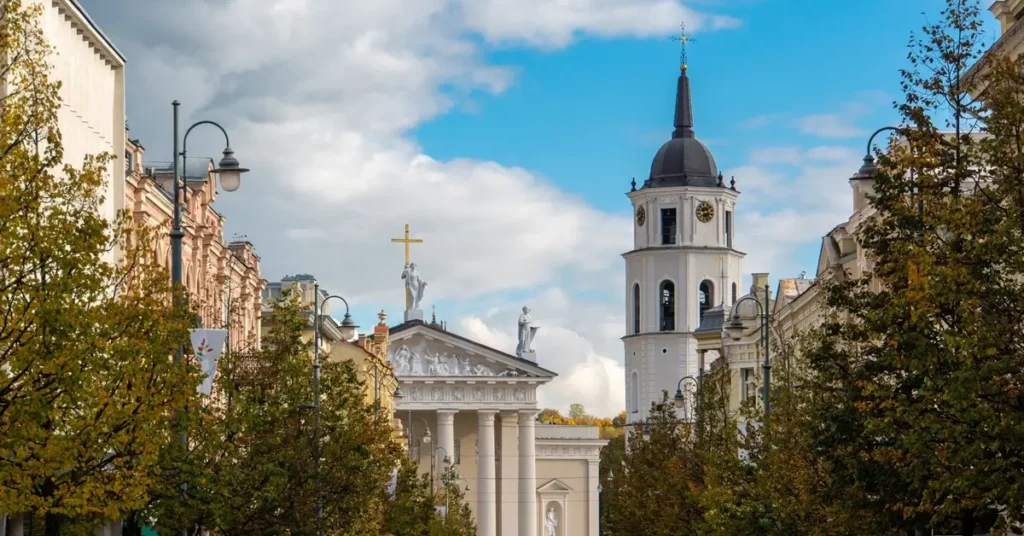 3 days itinerary of Vilnius: Vilnius Cathedral and Bell Tower framed by trees on a sunny day.