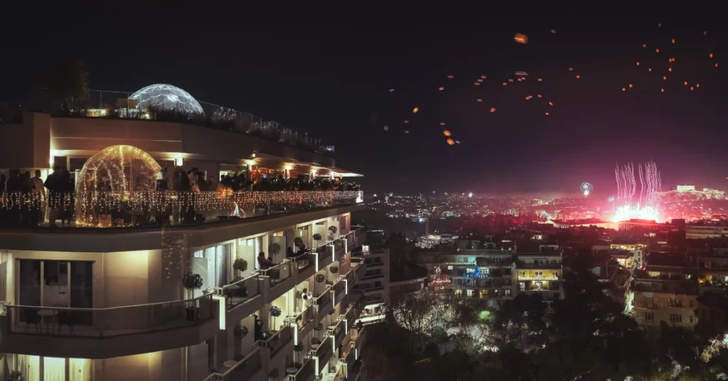 St. George Lycabettus Hotel: New Year's Eve rooftop celebration with fireworks lighting up the Athens skyline at night.