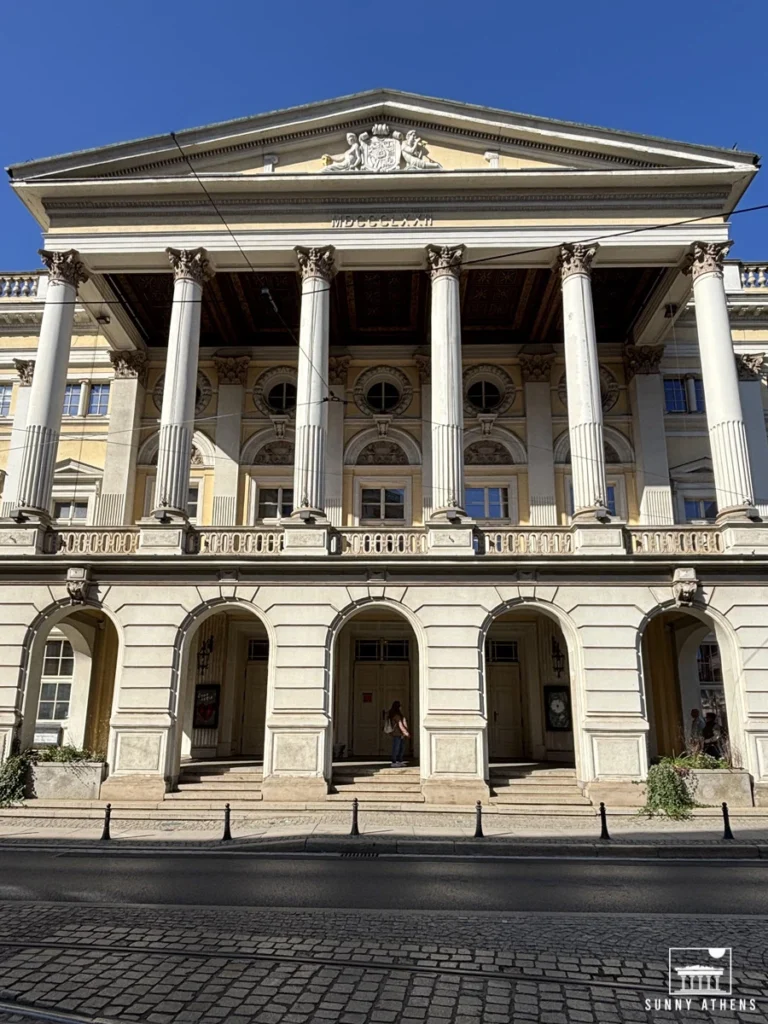 The neoclassical facade of the Wroclaw Opera with tall white columns.