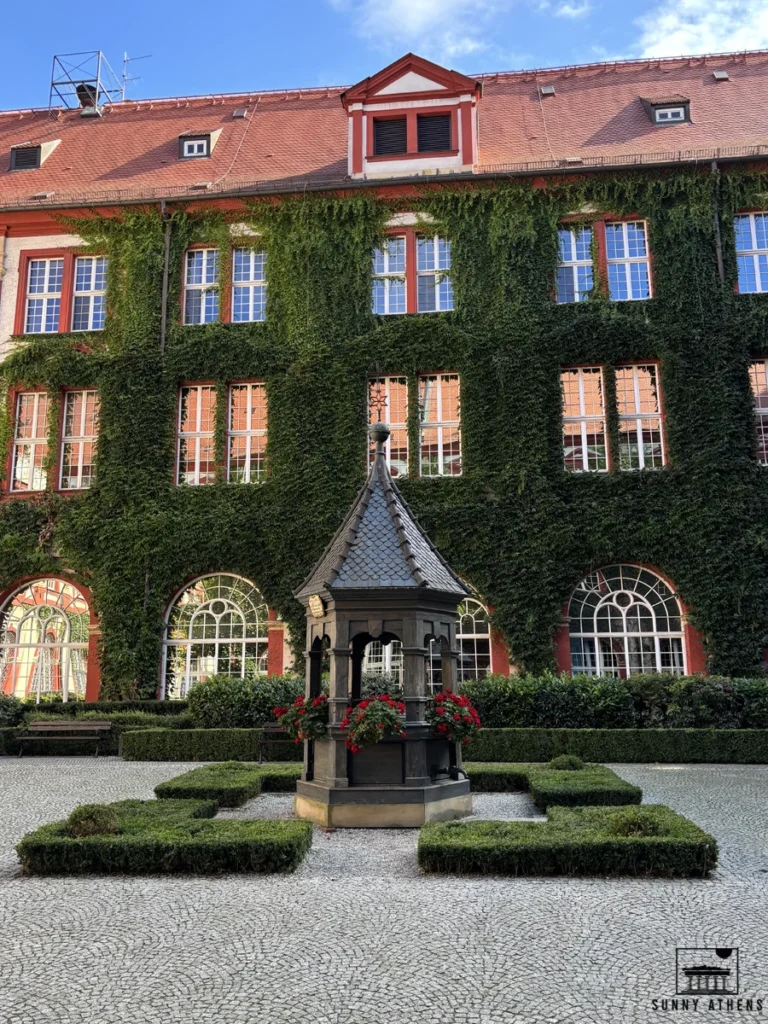 One day in Wroclaw Itinerary: the beautiful ivy-covered courtyard of the Ossolineum Institute.