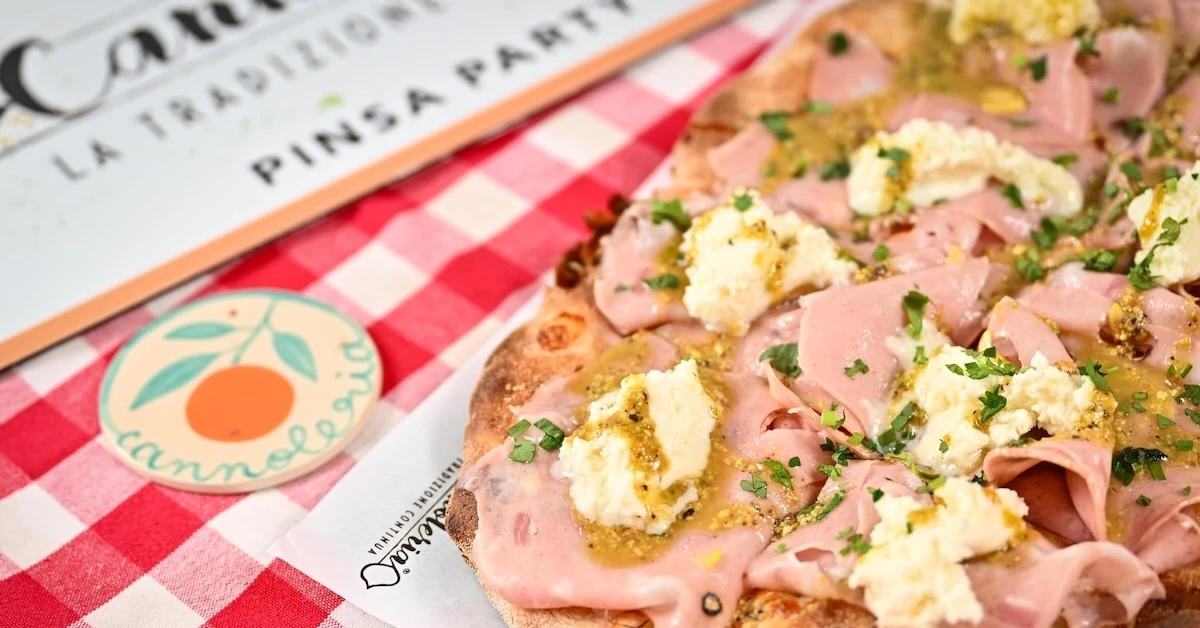 Italian pizza served on a red and white tablecloth at Cannoleria Dorobanti.