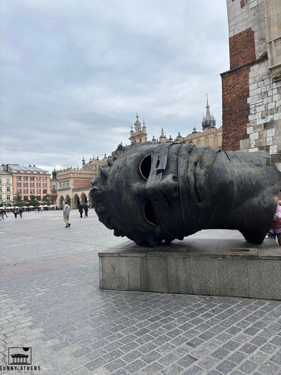 Krakow in 3 days: The "Eros Bendato" bronze head sculpture in Main Market Square (Rynek Glowny).