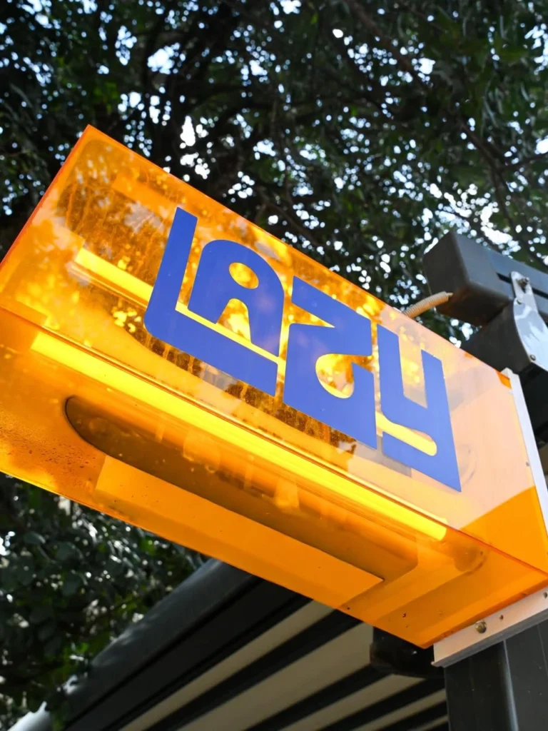 neon sign that says Lazy