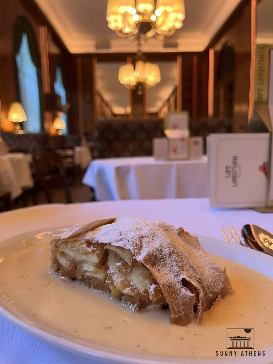 A traditional Austrian Apfelstrudel served with vanilla ice cream and whipped cream at Cafe Landtmann in Vienna