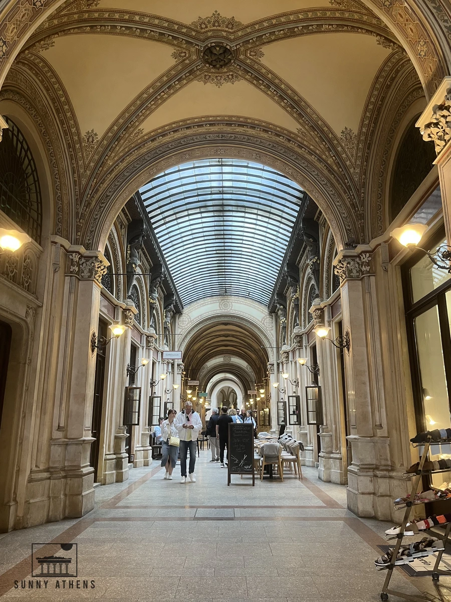 The elegant glass-vaulted interior corridor and marble columns of the Ferstel Passage in Vienna