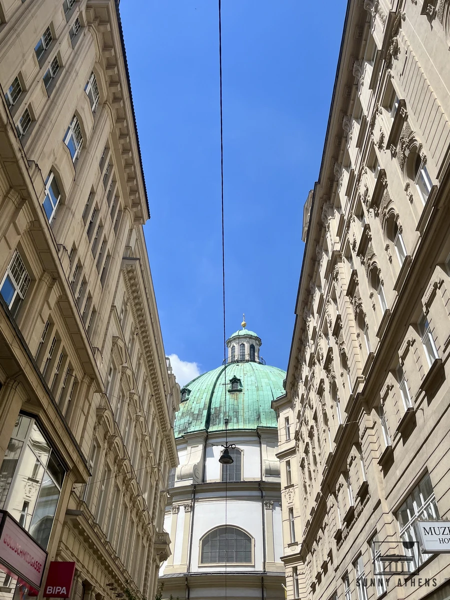The green dome and facade of St. Peter's Church (Peterskirche) in central Vienna