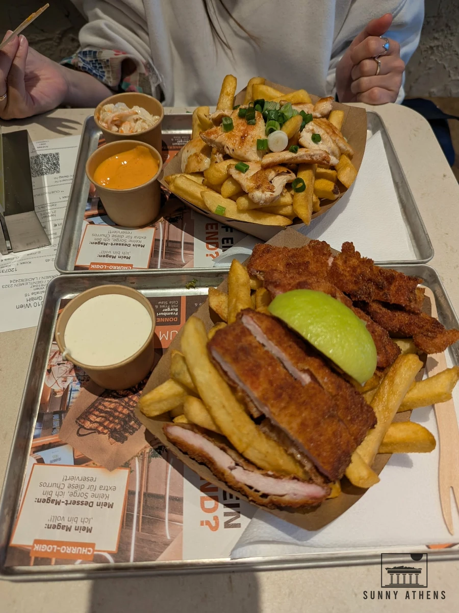 Crispy fries topped with schnitzel strips, parsley, and sauce at Framburi Fries in Vienna
