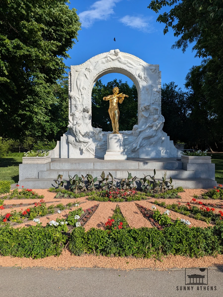The famous golden Johann Strauss monument framed by a marble arch in Stadtpark, Vienna