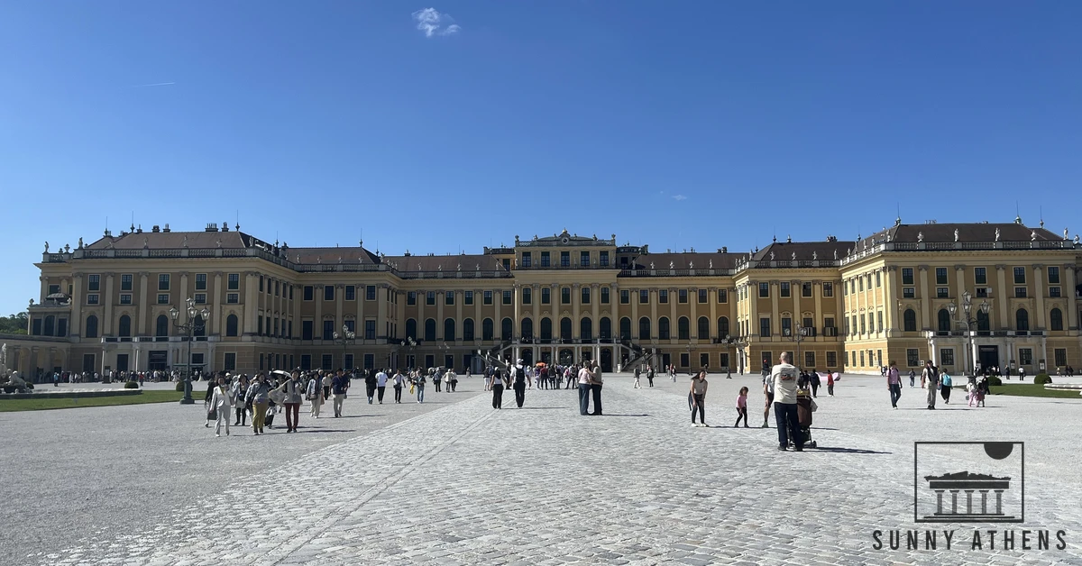 The large yellow facade and main courtyard of Schonbrunn Palace in Vienna