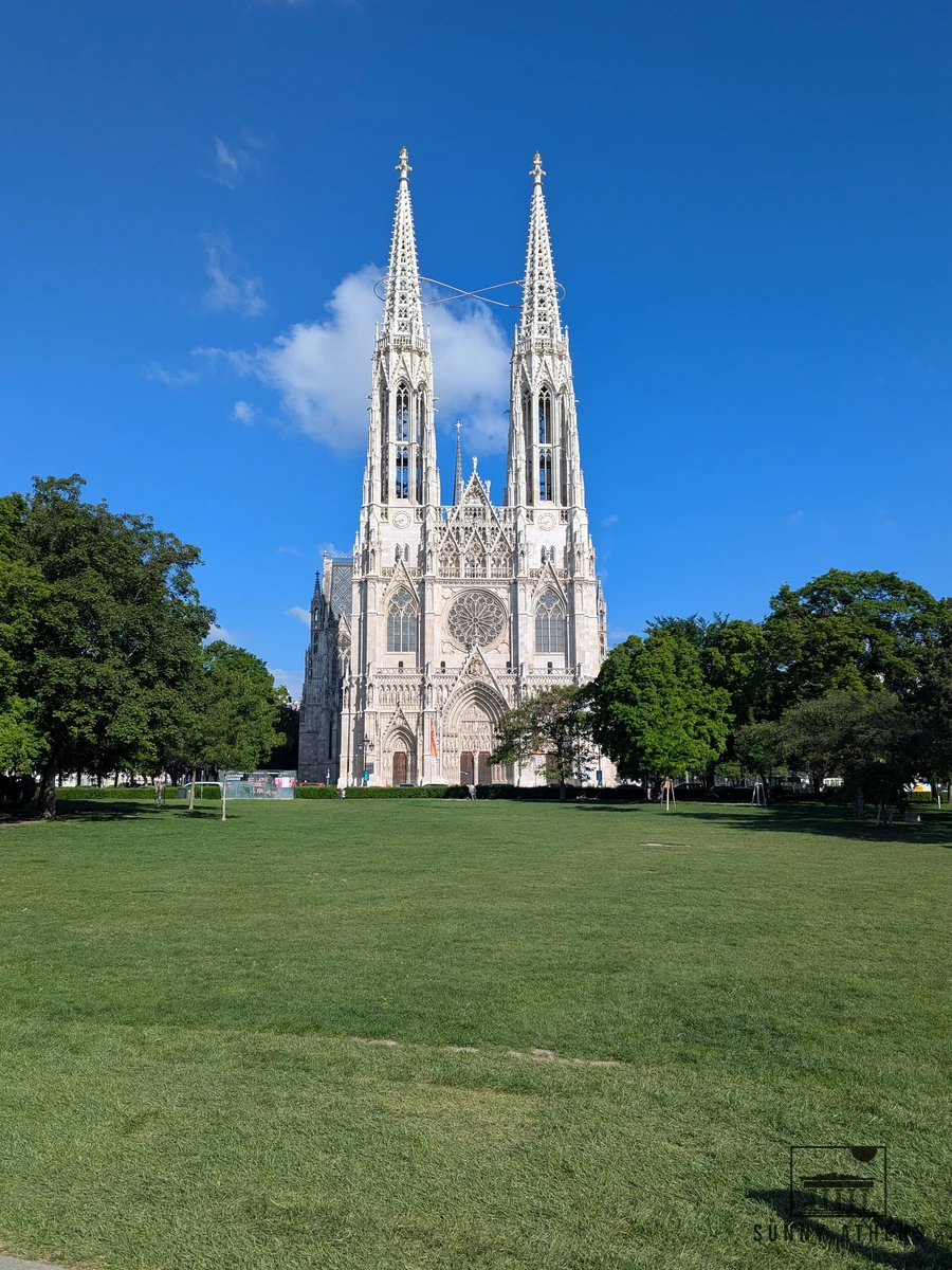 The twin spires of the Votivkirche rising above Sigmund Freud Park in Vienna