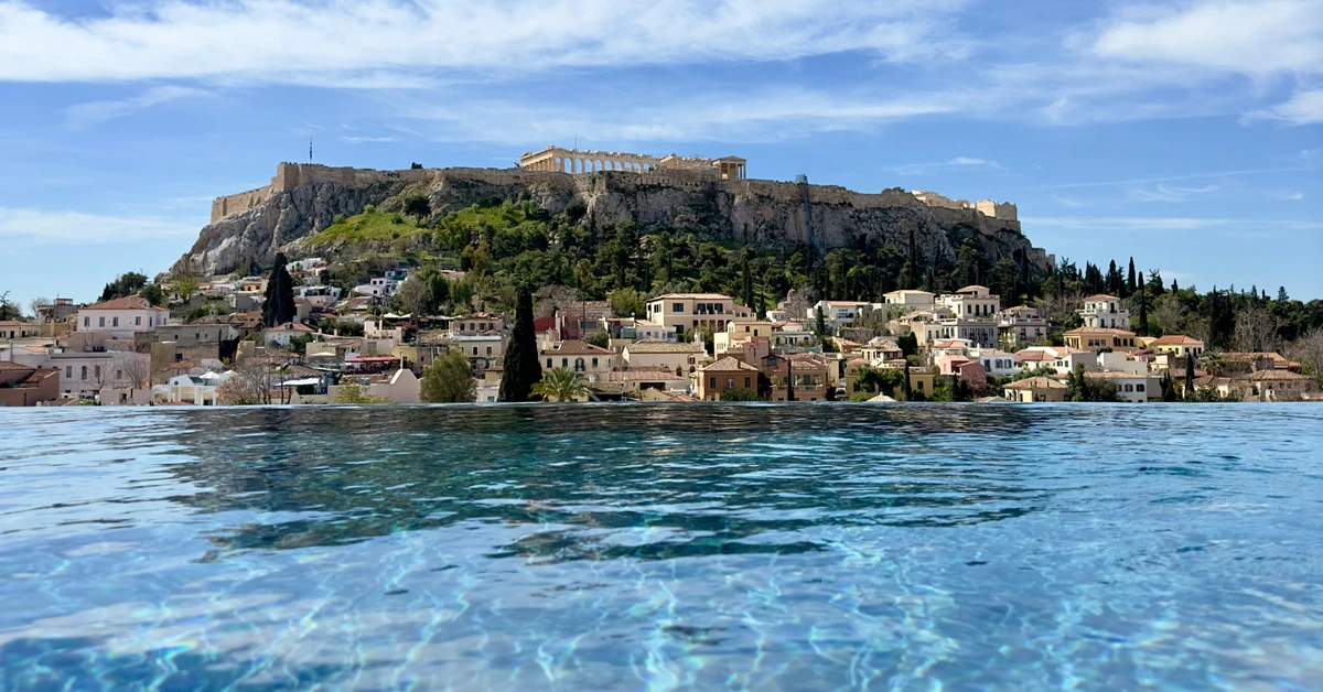 Rooftop infinity pool with a direct view of the Acropolis at The Dolli luxury hotel in Athens