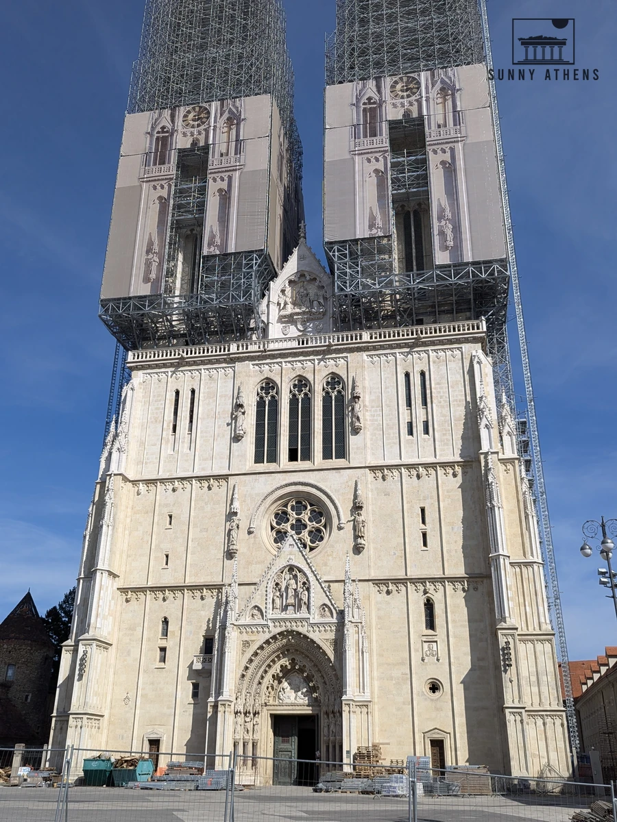 Neo-Gothic facade and twin 108-meter spires of the Cathedral of Zagreb under scaffolding