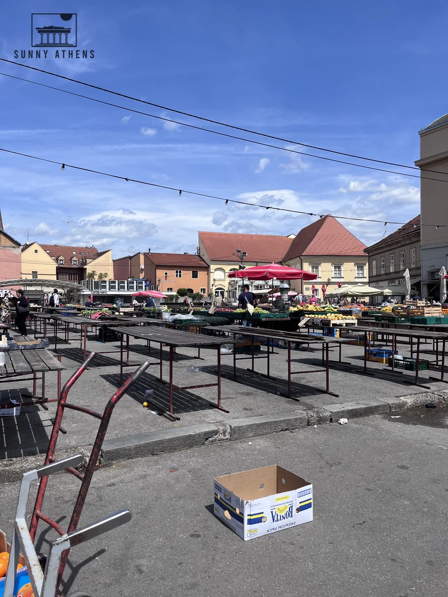 Wooden stalls and red umbrellas at Dolac outdoor farmers market