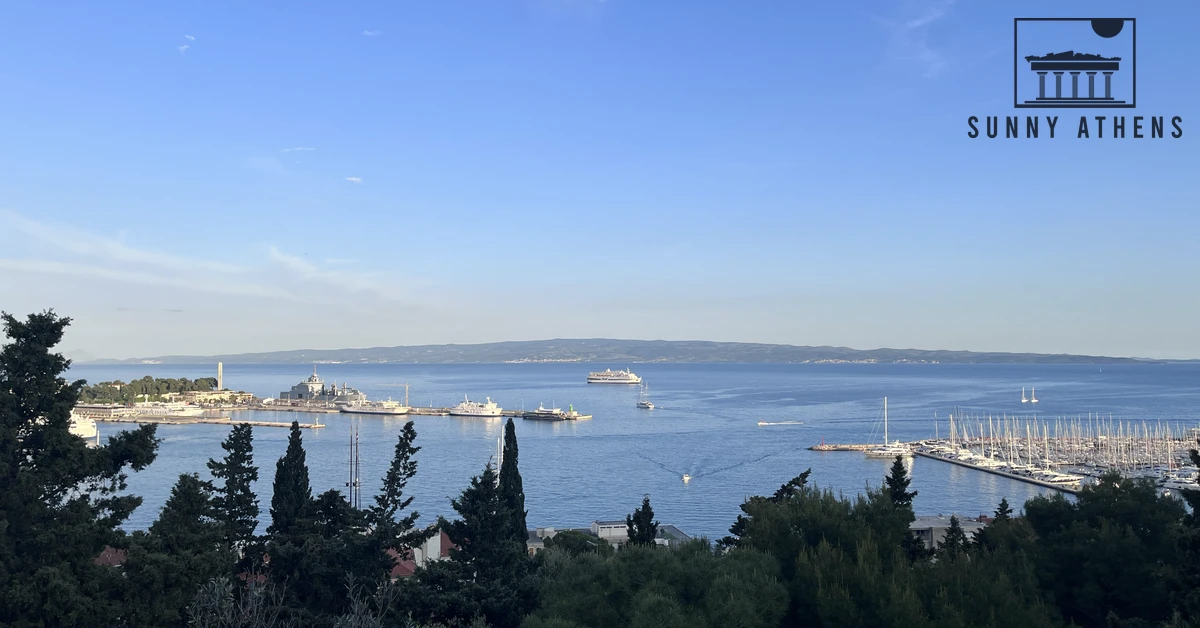 Panoramic view over pine trees toward the Adriatic Sea, marina, and passing boats from Marjan Forest Park