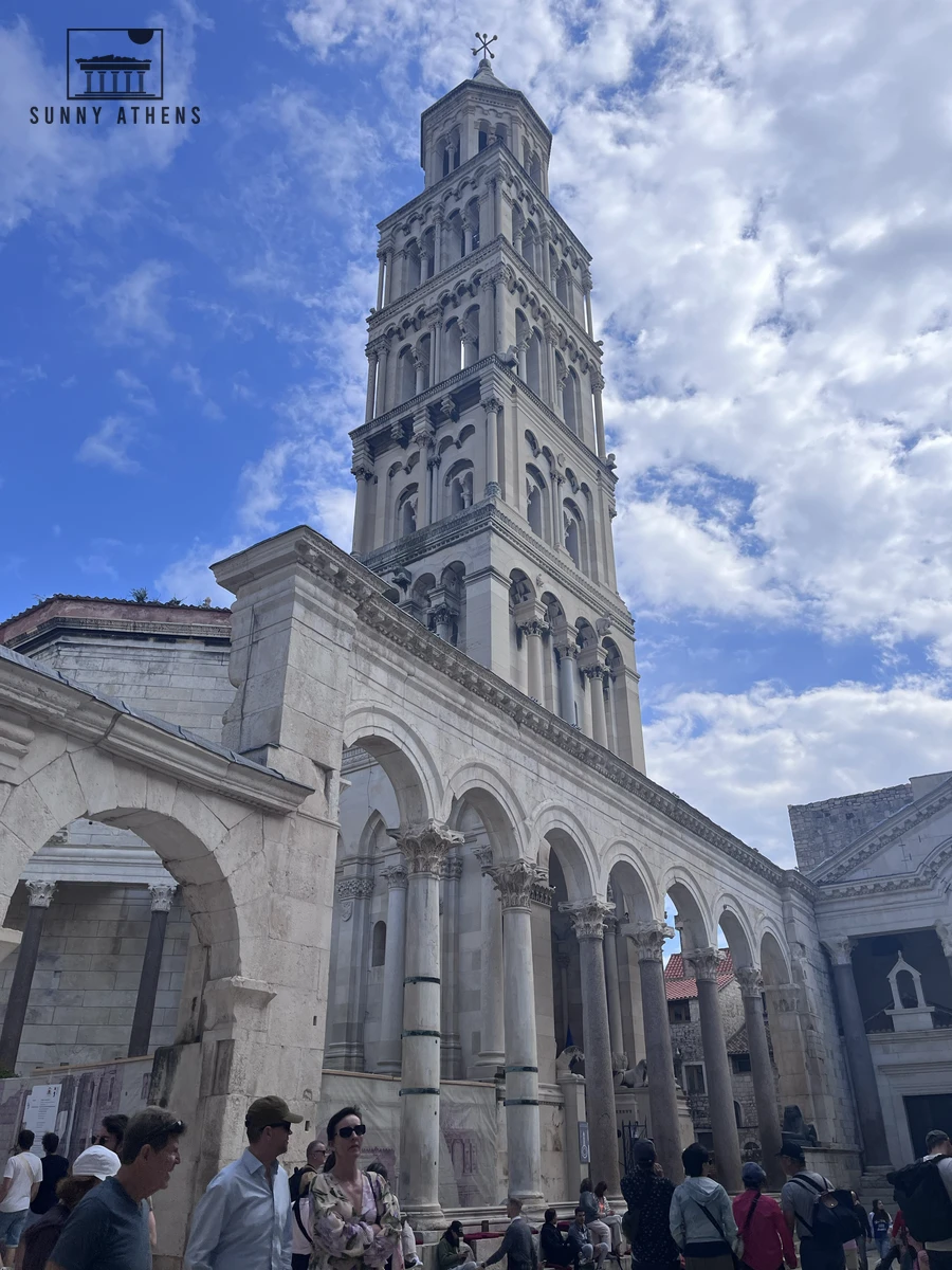 Tall Romanesque bell tower of Saint Domnius Cathedral rising above the stone arches of the Peristyle in Split