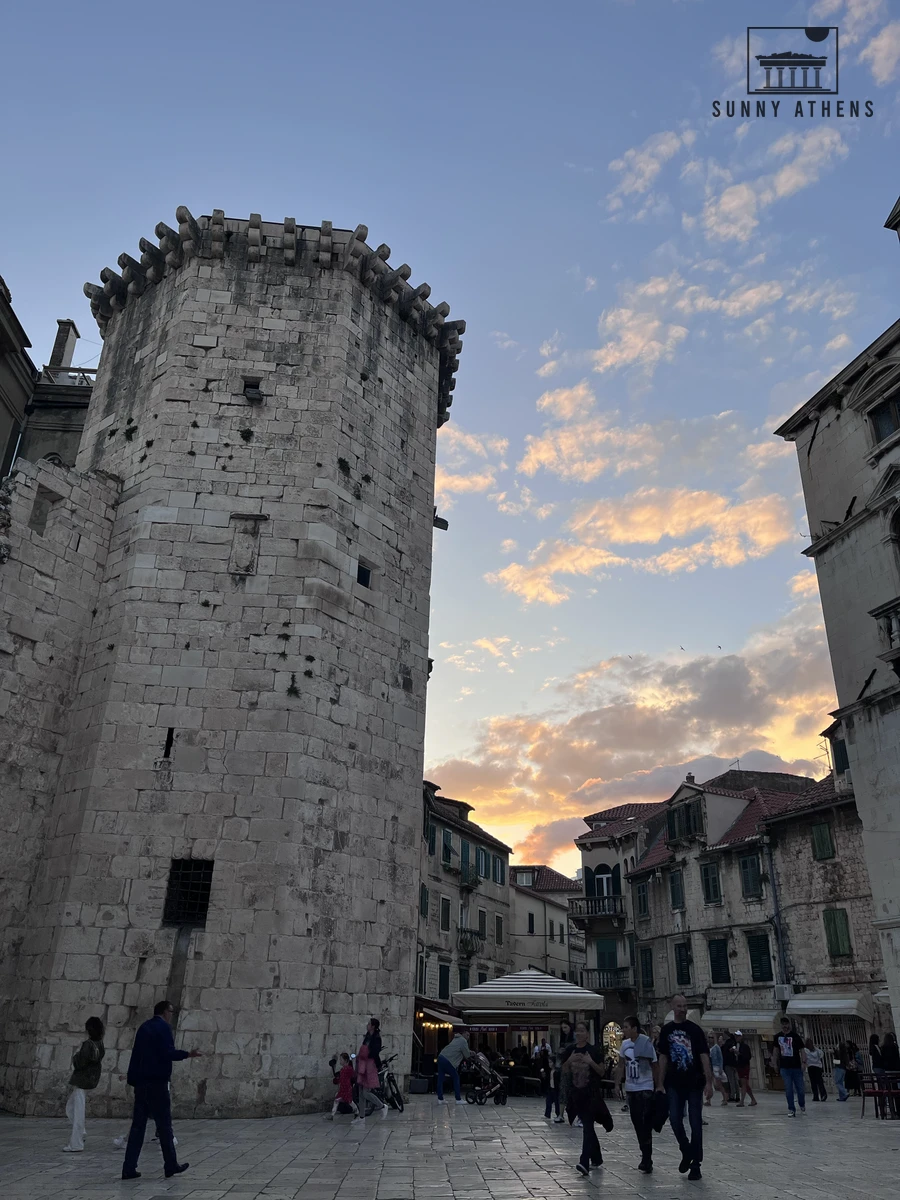 Octagonal stone Venetian Tower standing in Fruit's Square beneath a warm evening sunset sky in Split
