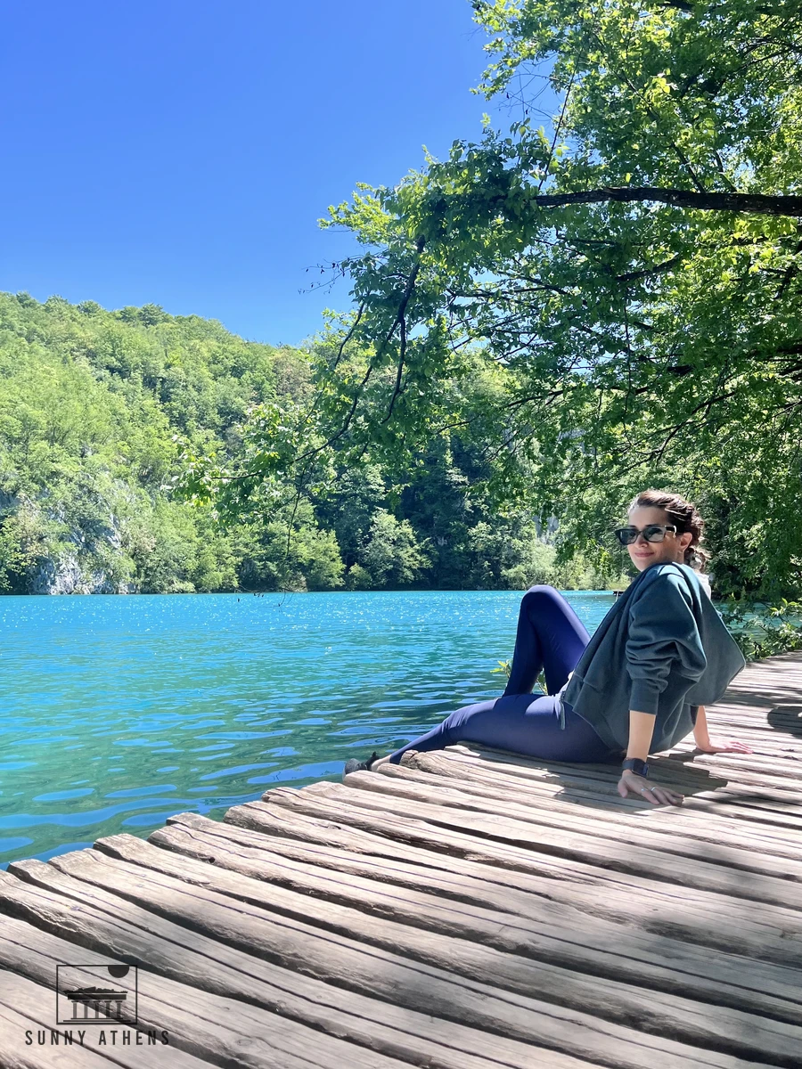 Resting on the wooden boardwalk path right next to the glowing turquoise lake water