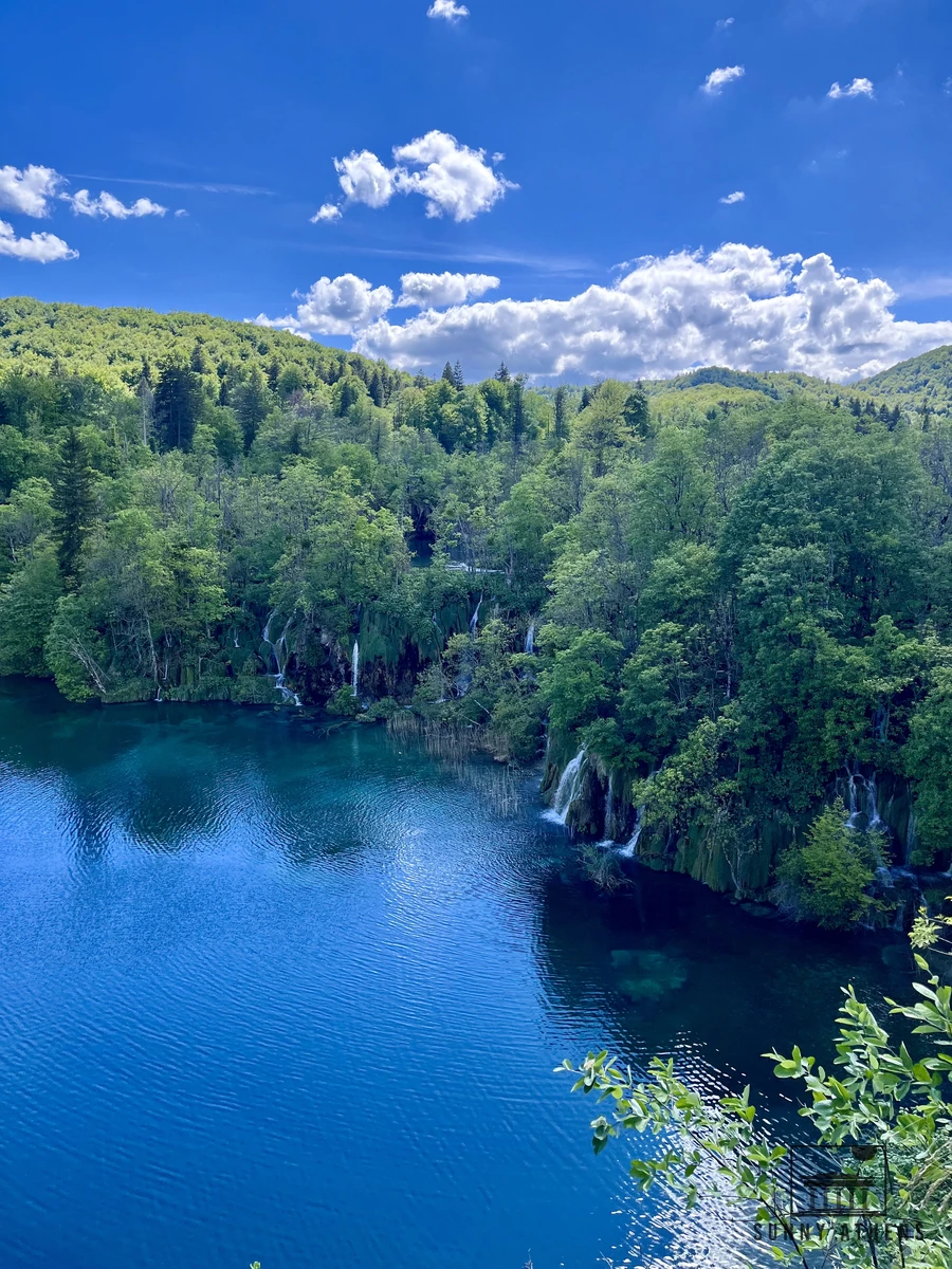 Deep blue lake surrounded by forested hills